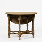 Table ovale antique à abattants et pieds rabattables