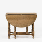 Table ovale antique à abattants et pieds rabattables